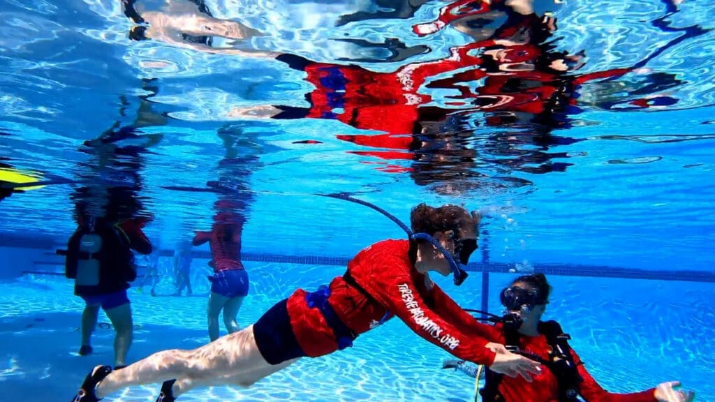 teaching-scuba-diving Pool operator instructing a diver using the BLU3 system.