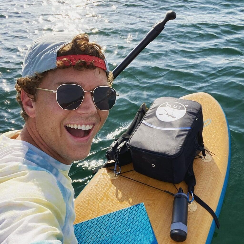 Dallas with BLU3 backpack on a paddle board with the Nomad BLU3 dive system inside the backpack