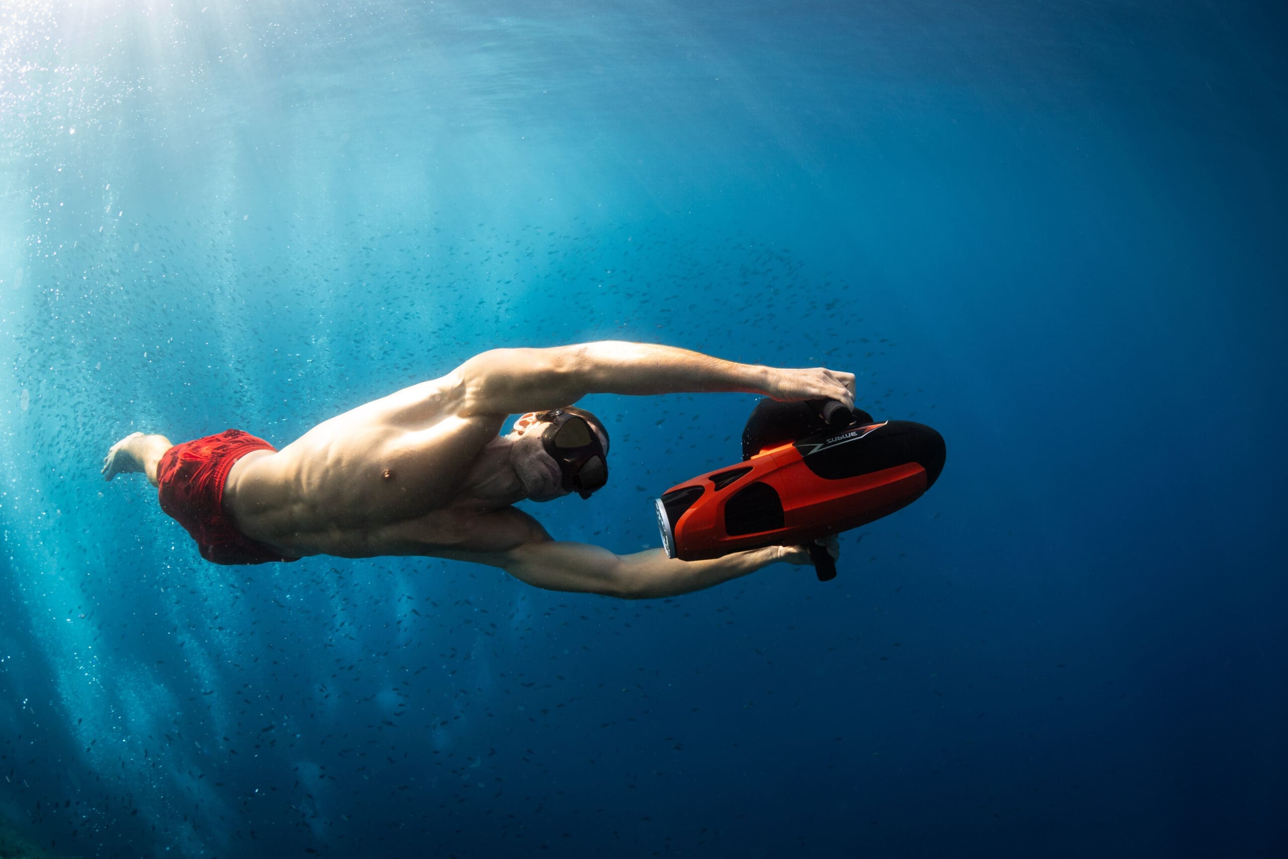 Sublue Vapor Sea Scooter in Action Underwater Man using Sublue Vapor underwater scooter while snorkeling in clear blue ocean