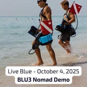 Two divers walking out of the ocean carrying BLU3 Nomad dive systems with dive flags during Live Blue demo event, October 4, 2025.