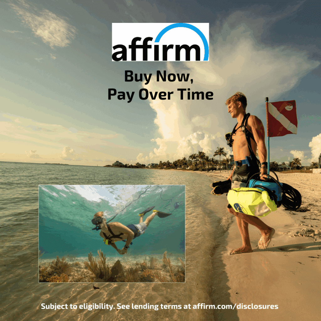 A diver carrying a BLU3 Nomad floating air compressor walks along the beach at sunset with dive flag and gear, while an underwater inset shows a diver using the Nomad system. Affirm logo appears above with text “Buy Now, Pay Over Time.” Caption reads “Subject to eligibility. See lending terms at affirm.com/disclosures.”